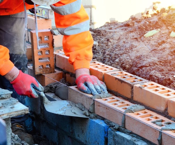 A bricklayer working on a construction site.