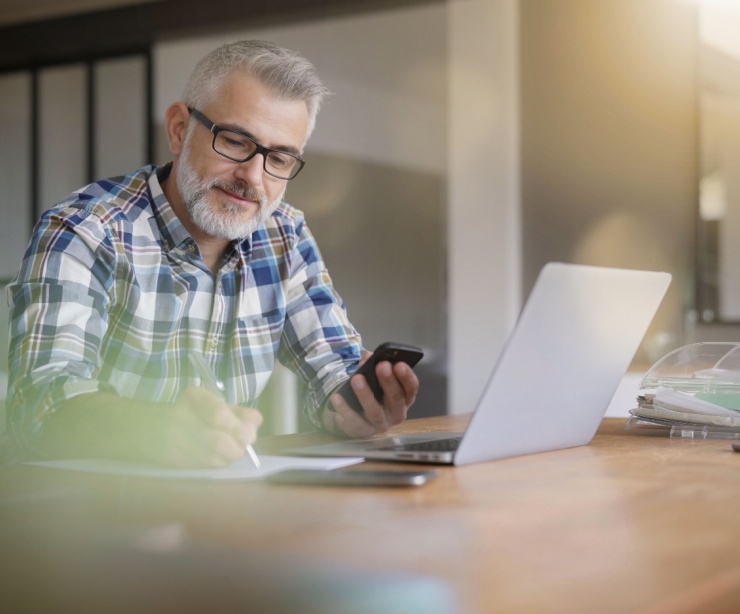 A man using a computer in a home office.