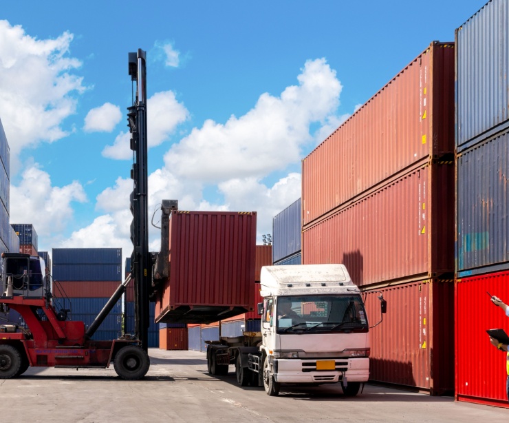 A foreman organising containers from a cargo ship.