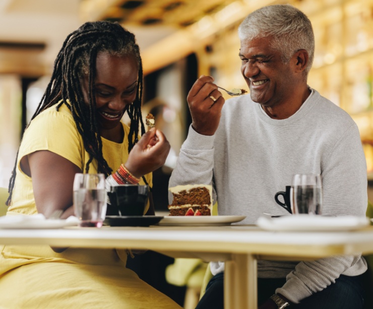 A couple laughing together at a café.