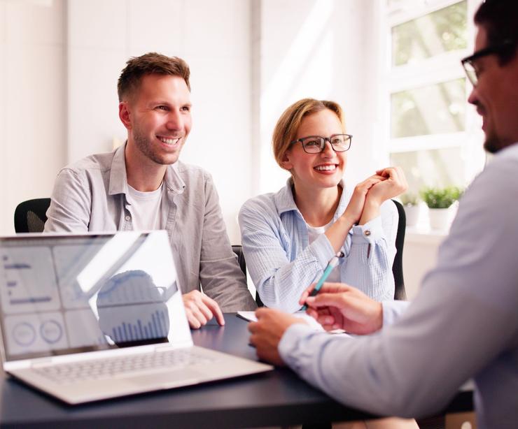 A young couple meeting with a financial planner.
