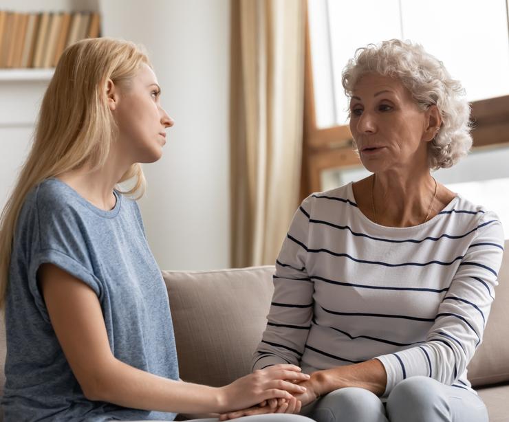 A mother and adult daughter talking.
