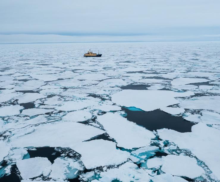 A ship cruising through sea ice.