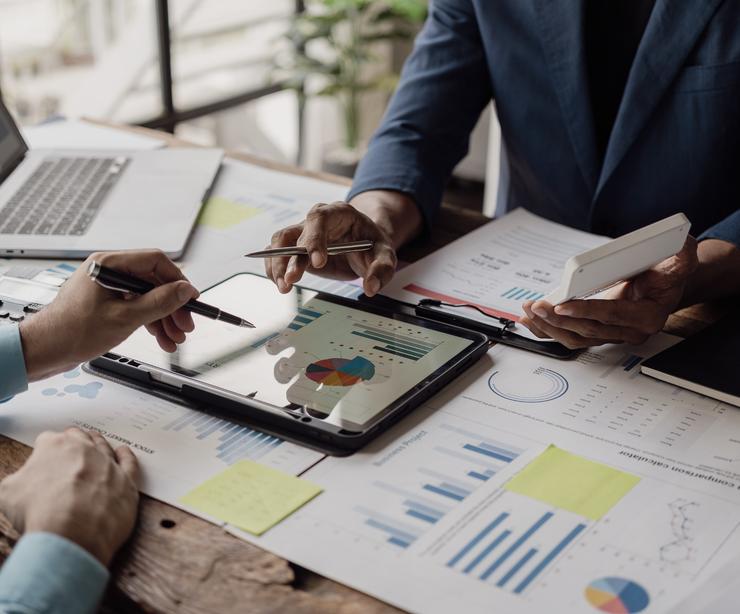Business people looking at documents in an office.
