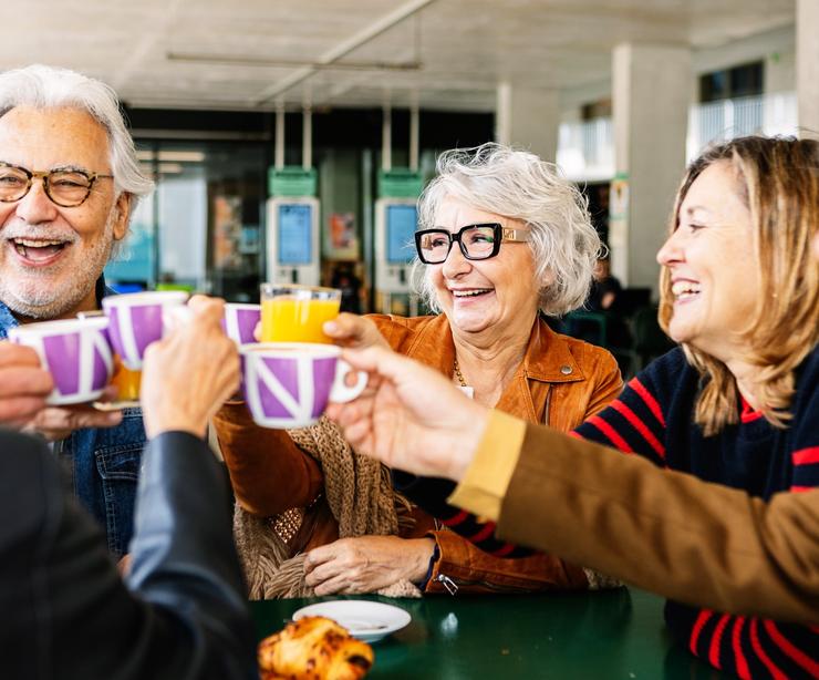 A group of people talking and drinking tea.