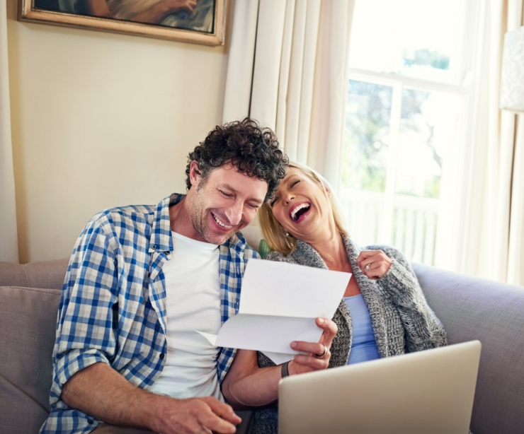 A happy couple reviewing paperwork.