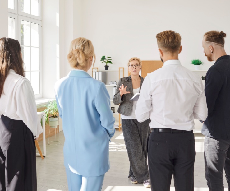 A business owner talking with her employees.