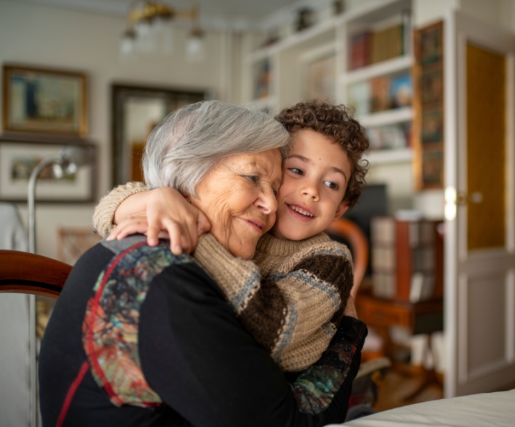A woman hugging her grandchild.