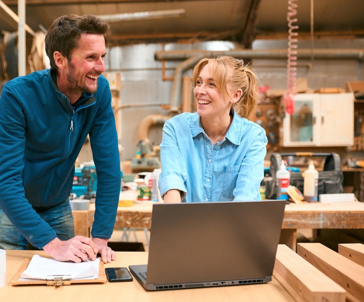 Two people in a woodwork workshop.