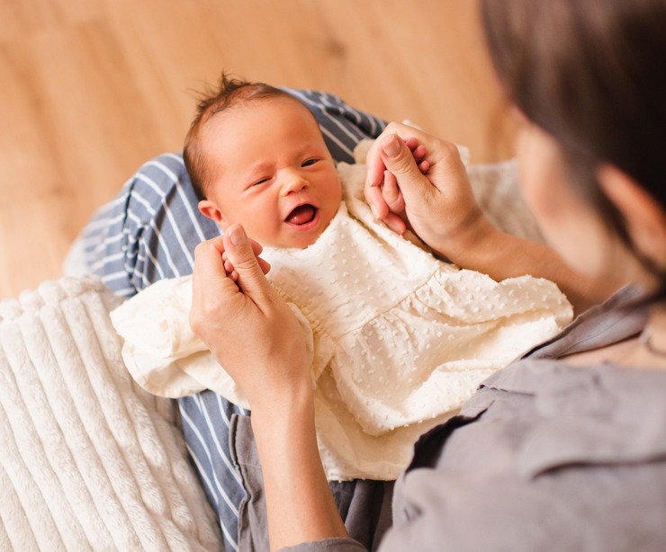 A mother holding a baby.