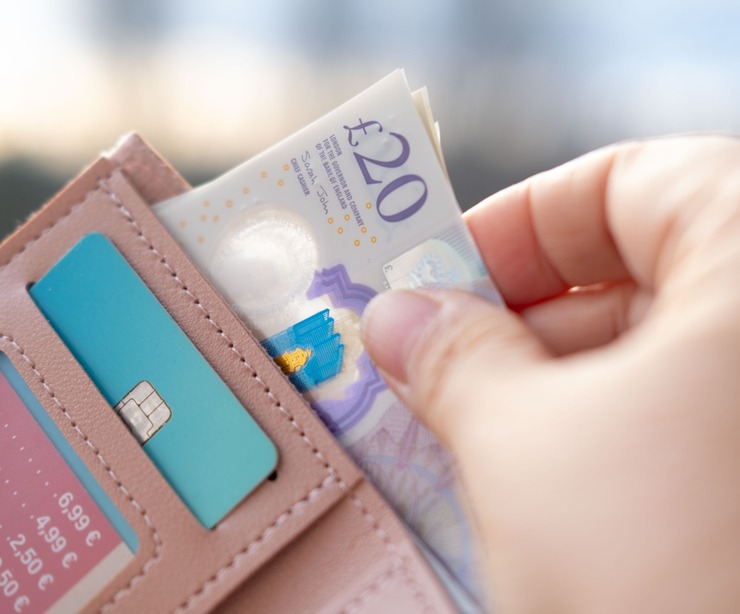 Someone taking money out of a wallet.