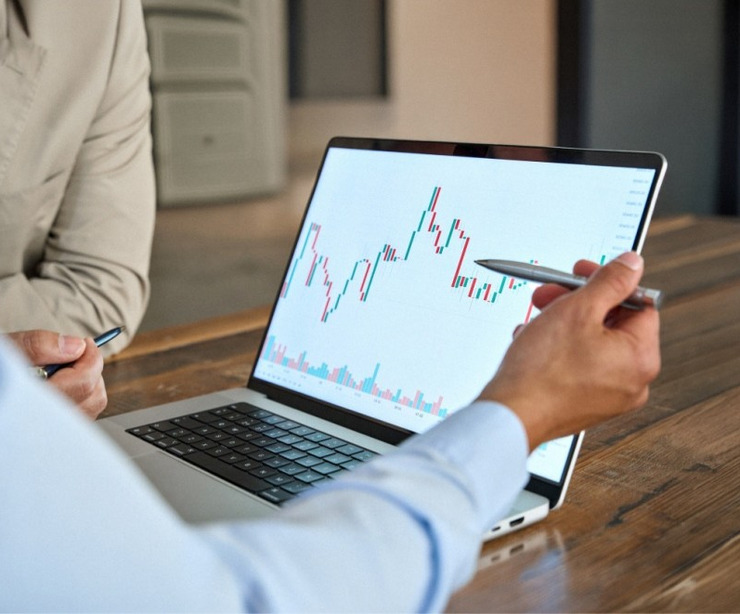 A man reviewing stock market movements on a laptop.